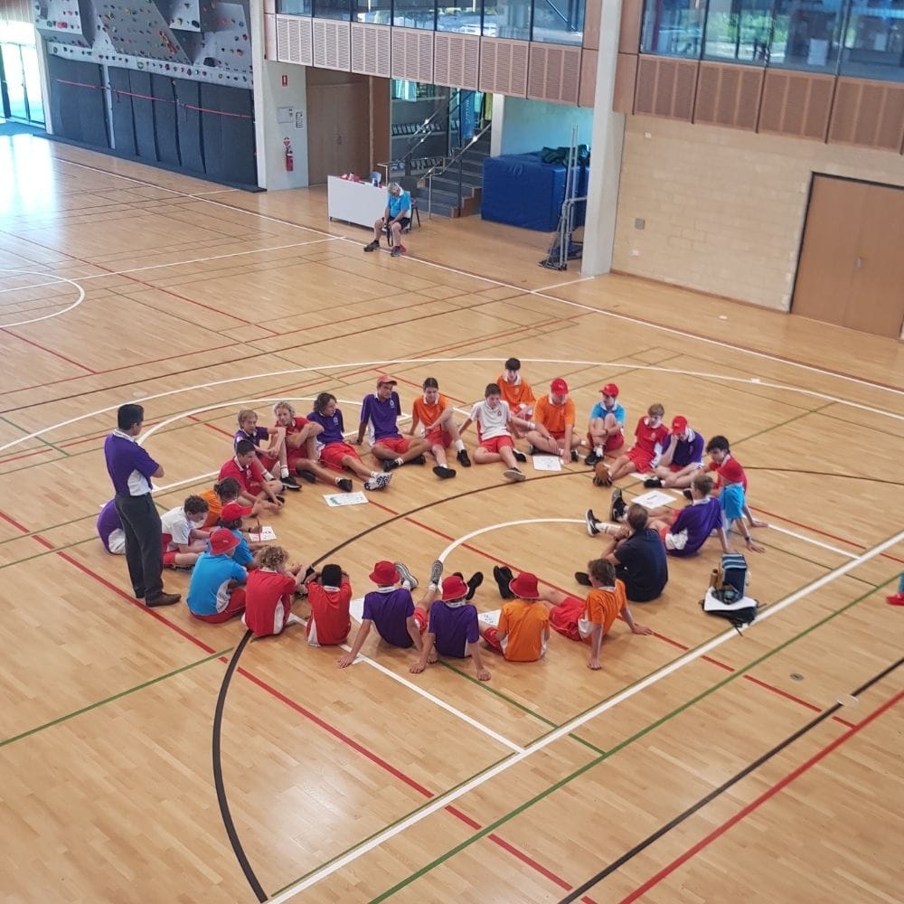 Blog feature image of students sitting in circle to represent student leadership in schools