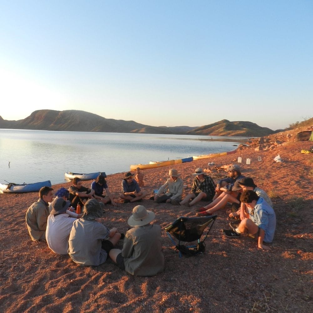 Students sit outside while learning