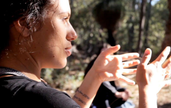 Teacher guiding students in outdoor camp